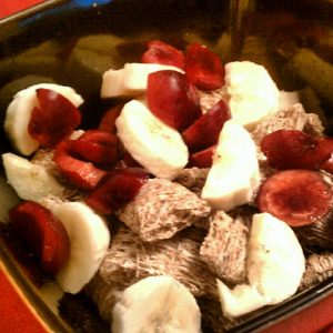 Instead of juice, add whole fruits to your cereal in the morning. Pictured: bing cherries and sliced banana with shredded wheat.